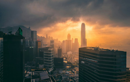 Dramatic sunset over skyscrapers in the city of Hong Kongの写真素材