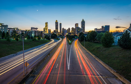 Atlanta, Georgia, USA downtown city skyline at dusk with car light trails.