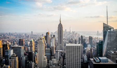 New York City Manhattan skyline panorama with Empire State Building at sunset.の写真素材