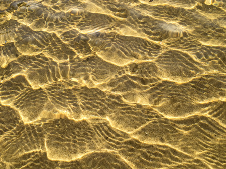 Yellow sand waves in shallow water  の写真素材