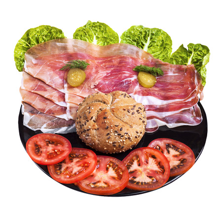 Happy face  made of vegetables, ham and breadroll on wooden board.の写真素材