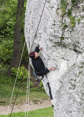  Man climbing rocky wall.の写真素材
