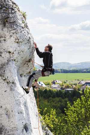  Man climbing natural difficult rocky wall.の写真素材