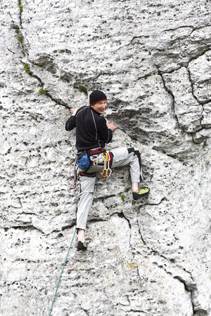  Man climbing natural rocky wall.の写真素材