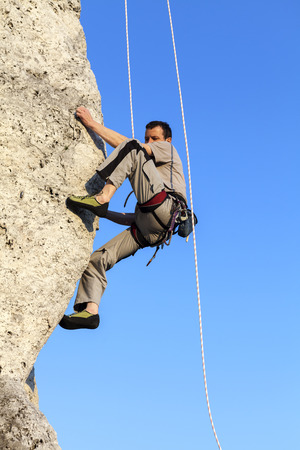 Difficult rock climbing position on horizontal cliff, mountains in Poland.の写真素材