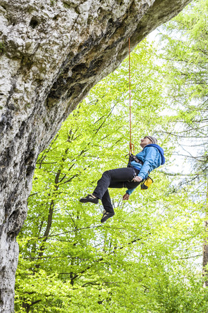 Female climber, woman climbing rock.の写真素材