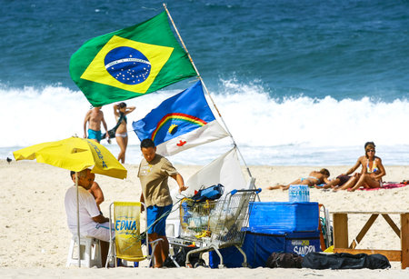 RIO DE JANEIRO, BRAZIL - AUGUST 27, 2008  Copacabana beach in summer day, vendors and sunbathers のeditorial素材