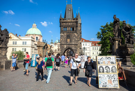 PRAGUE, CZECH REPUBLIC - JUNE 12, 2014   Tourists, street artists and vendors on Charles Bridge, one of the most famous place in the city のeditorial素材
