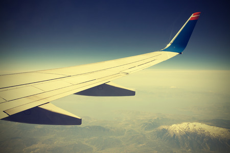 Wing of the plane on blue sky の写真素材