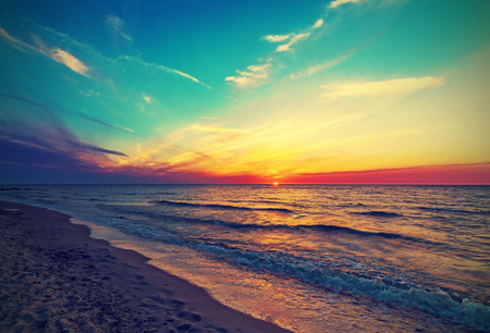 Vintage retro photo of beach at sunset の写真素材