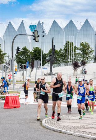 SZCZECIN, POLAND - JULY 06, 2014  Triathletes on the street during first Triathlon Szczecin Race のeditorial素材
