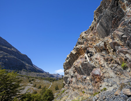 Happy girl climbing rock の写真素材
