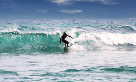 Mirissa, Sri Lanka - March 04, 2009  Silhouette of a surfer on waves on famous beach in Sri Lanka のeditorial素材