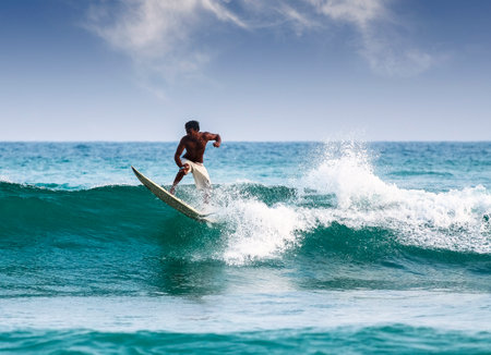 Mirissa, Sri Lanka - March 04, 2009  Silhouette of a surfer on waves on famous beach in Sri Lanka のeditorial素材
