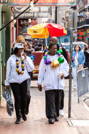 New Orleans, USA - February 17, 2011: People wearing funny costumes celebrating famous Mardi Gras carnival on the street in French Quarter.のeditorial素材