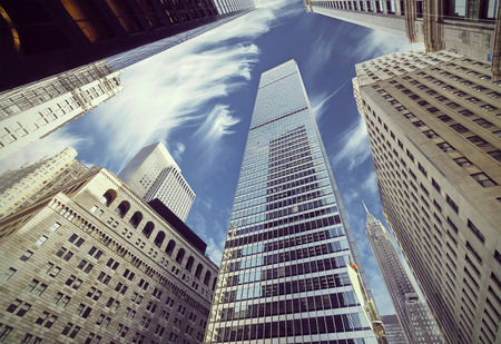 Retro filtered view of skyscrapers in Lower Manhattan, looking up at sky, New York City.の写真素材