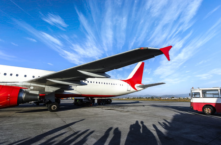 Airplane and shadows of waiting people.の写真素材
