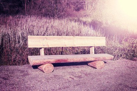 Retro vintage filtered picture of wooden bench.