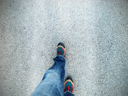 Concept picture of legs walking on asphalt.の写真素材