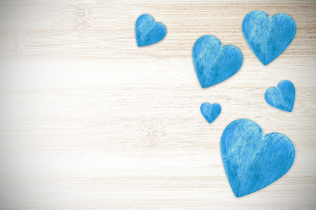 Wooden blue hearts on timbered background, space for text.の写真素材