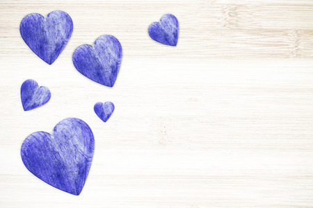 Wooden hearts on timbered background, space for text.の写真素材