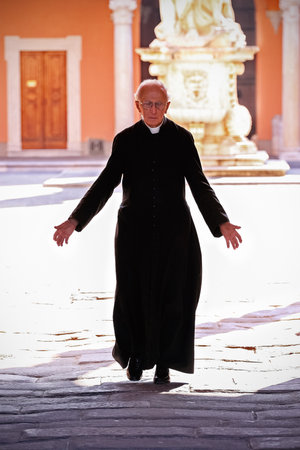 Pisa, Italy - September 12, 2009: Priest walking on the churchyard in the old town of Pisa.のeditorial素材