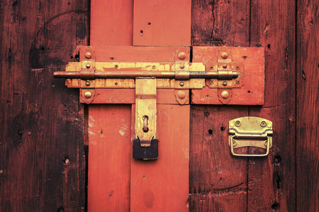 Retro vintage style picture of wooden door with lock.の写真素材