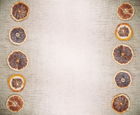 Vintage natural background, dried orange on jute fabric.の写真素材