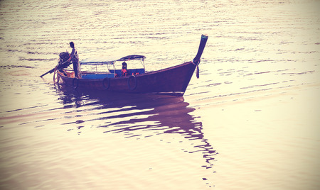 Retro filtered picture of a boat on the Krabi River.の写真素材