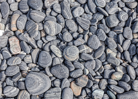 Nature background made of dry round stones.の写真素材