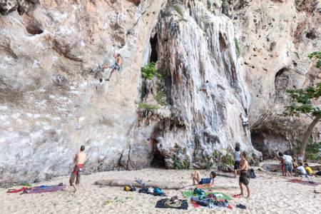 Railay, Thailand - December 31, 2014: Rock climbers and tourists on Railay beach, one of the most popular rock climbing locations in Asia.のeditorial素材