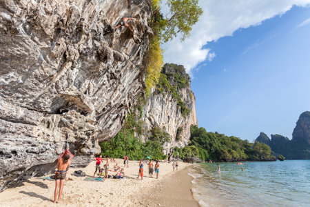 Railay, Thailand - December 31, 2014: Rock climbers and tourists on Railay beach, one of the most popular rock climbing locations in Asia.のeditorial素材