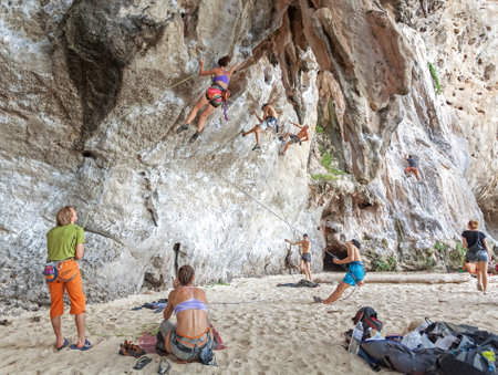 Railay, Thailand - December 31, 2014: Rock climbers climbing the wall on Railay beach, one of the most popular rock climbing locations in Asia.のeditorial素材
