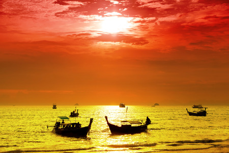 Intense colored sunset over peaceful ocean.の写真素材