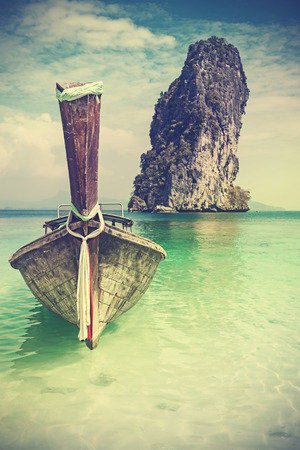 Retro vintage filtered picture of a wooden boat on beach.の写真素材