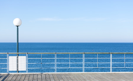 Background or banner with sea, pier and lamp, space for text.の写真素材