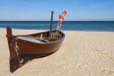 Fishing boat on the beach, space for text.の写真素材