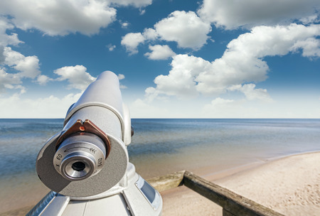 Telescope on a beach pointed at beautiful sky.の写真素材