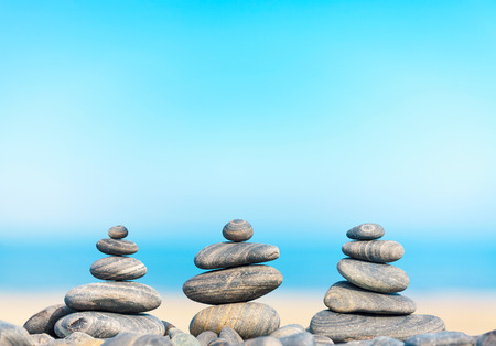 Stone pyramids on beach, Zen spa concept background.の写真素材
