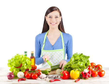 Young woman preparing salad. Healthy food and diet concept. Isolated on white.の写真素材