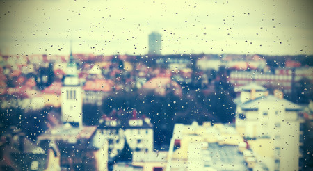 Retro style abstract urban background made of rain drops on window.の写真素材