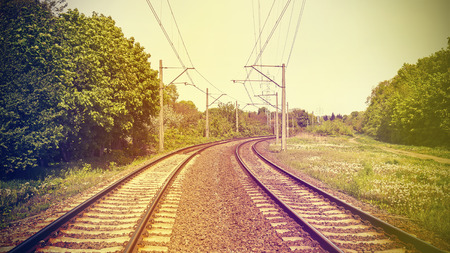 Vintage retro filtered picture of railroad tracks, old film effect applied.の写真素材