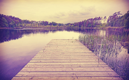 Vintage toned wooden lake pier.の写真素材