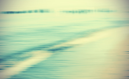 Motion blurred sea background, retro cross processed colors.の写真素材
