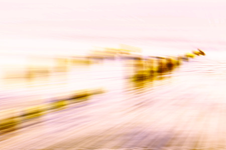Motion blurred abstract background, wooden posts on beach.の写真素材