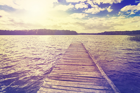 Vintage toned photo of beautiful sunset over lake, Ostromecko in Poland.の写真素材