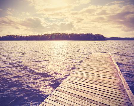 Vintage  filtered wooden pier at sunset.の写真素材