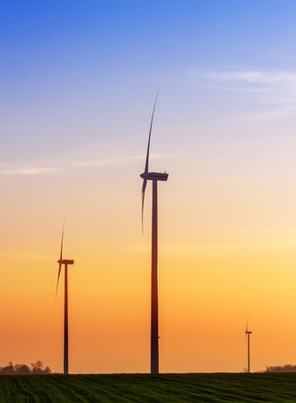 Alternative energy concept, windmills at sunset.の写真素材