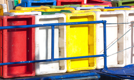 Colorful plastic fish containers in a port.の写真素材