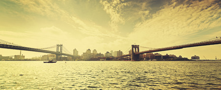 Old film retro style New York waterfront view with famous Brooklyn and Manhattan Bridges, USA.